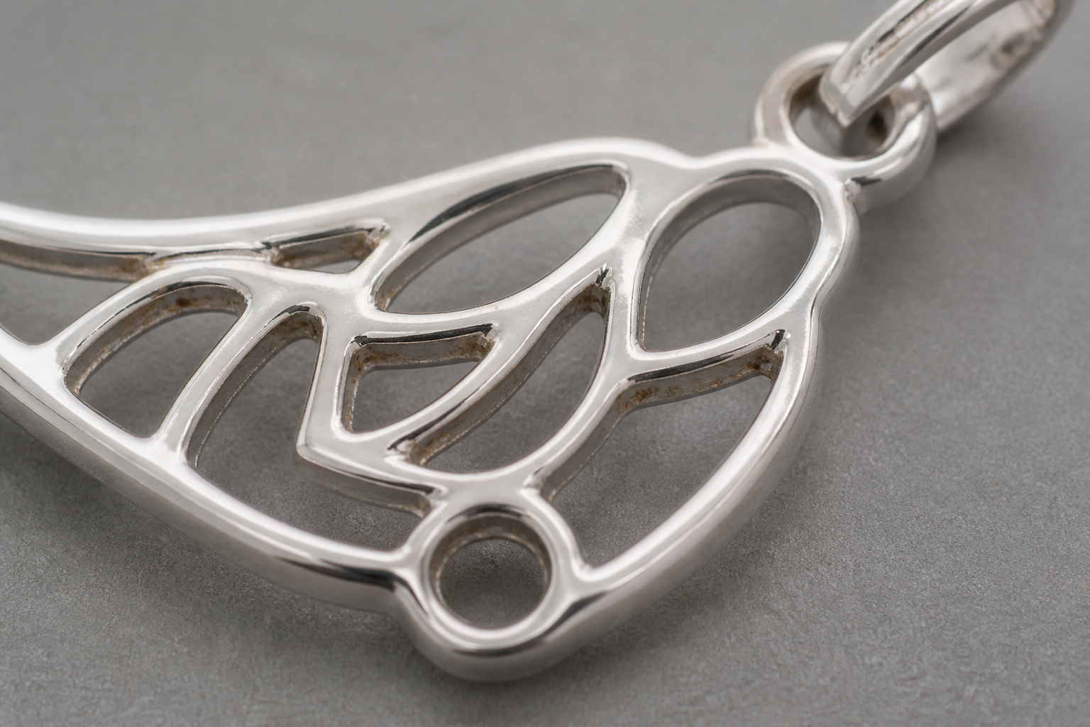 Localized brown discoloration in the recesses of a polished metal component.