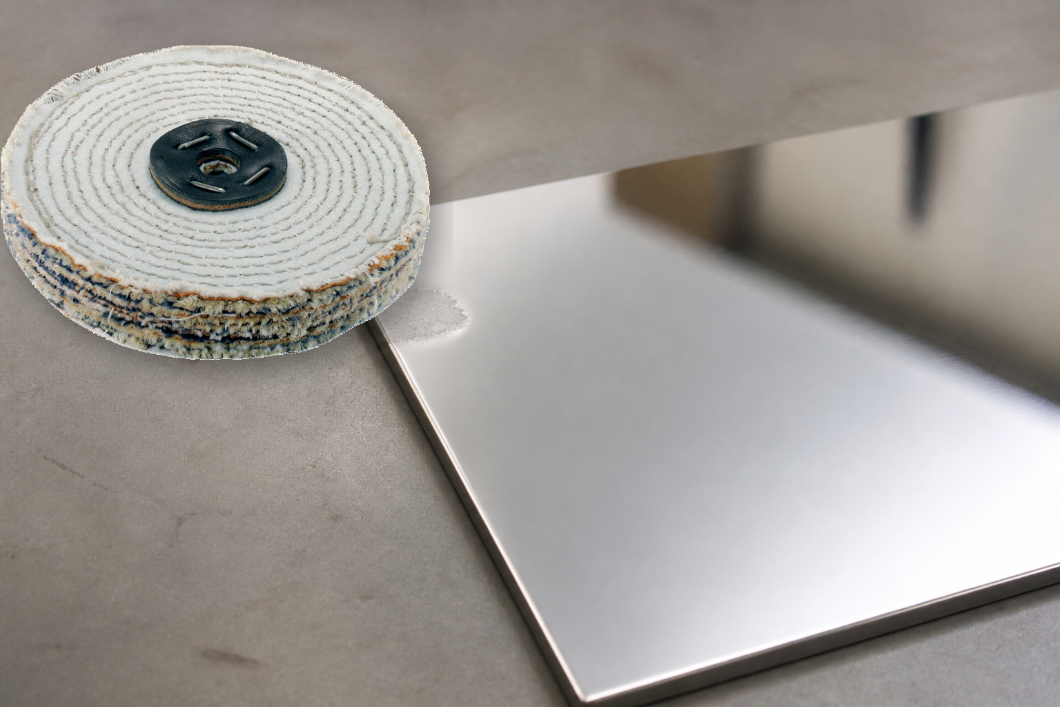 A sisal wheel beside a mirror-bright metal surface with one localized freshly roughened patch.