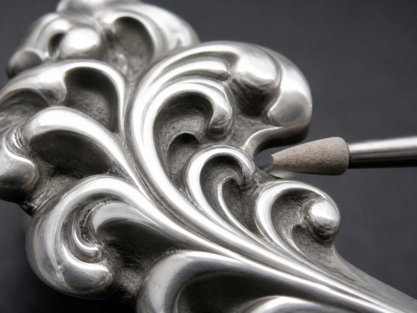Bright raised relief beside dull recessed channels and a stopped small finishing tool.