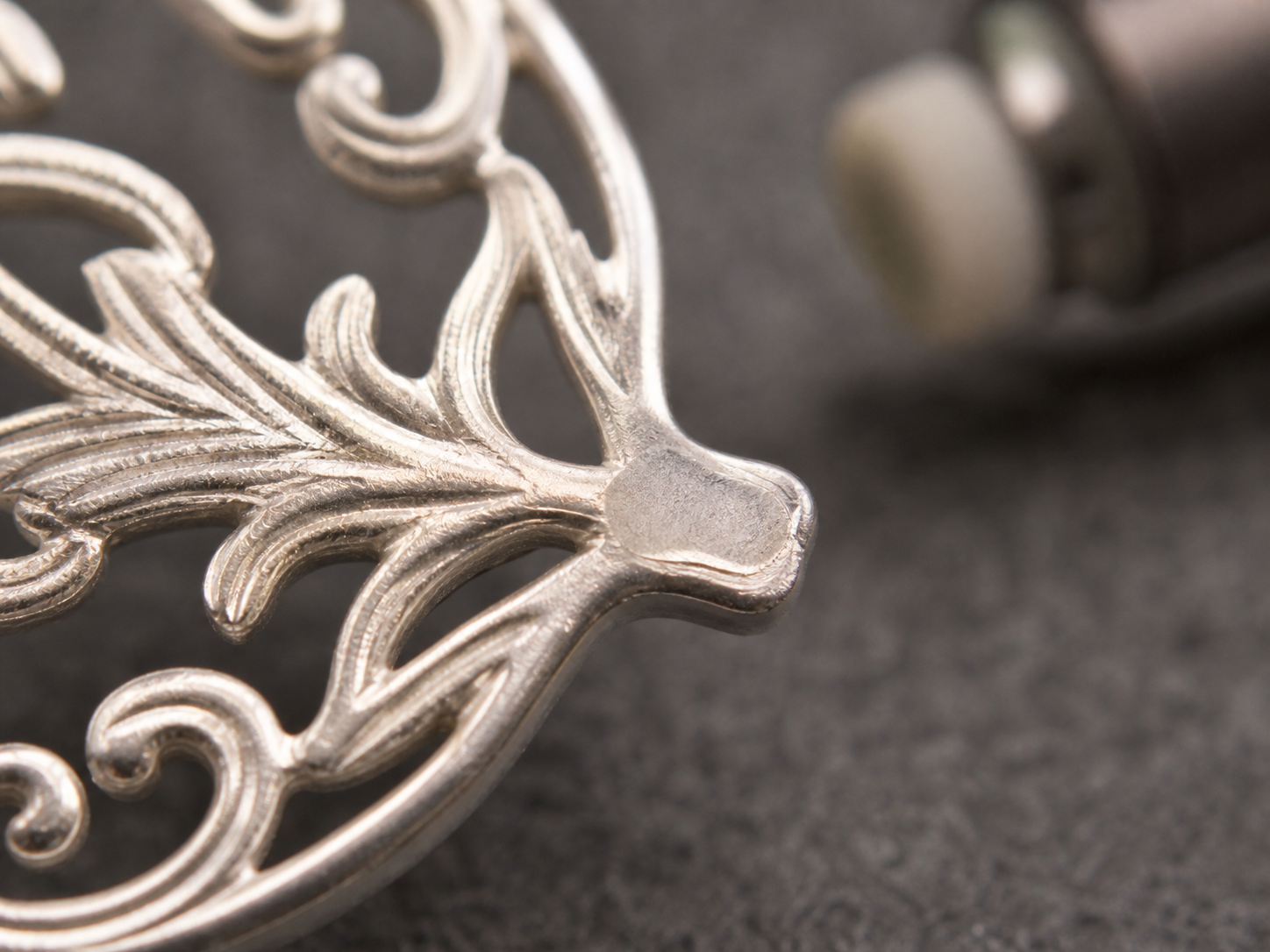 Delicate openwork with one flattened abraded patch beside preserved fine relief.